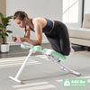 A woman performs an exercise using an adjustable core abdominal trainer on a light-colored floor.