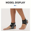 Model display of a black and gray adjustable ankle compression strap worn on a foot.