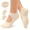 Two pairs of beige silicone yoga pilates socks shown on a person's foot.
