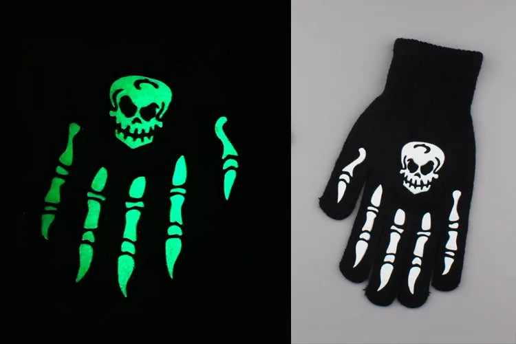 A pair of luminous green skeleton hand gloves displayed against a black background and on a white surface.