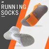 A pair of grey and orange running socks are shown against a white background.