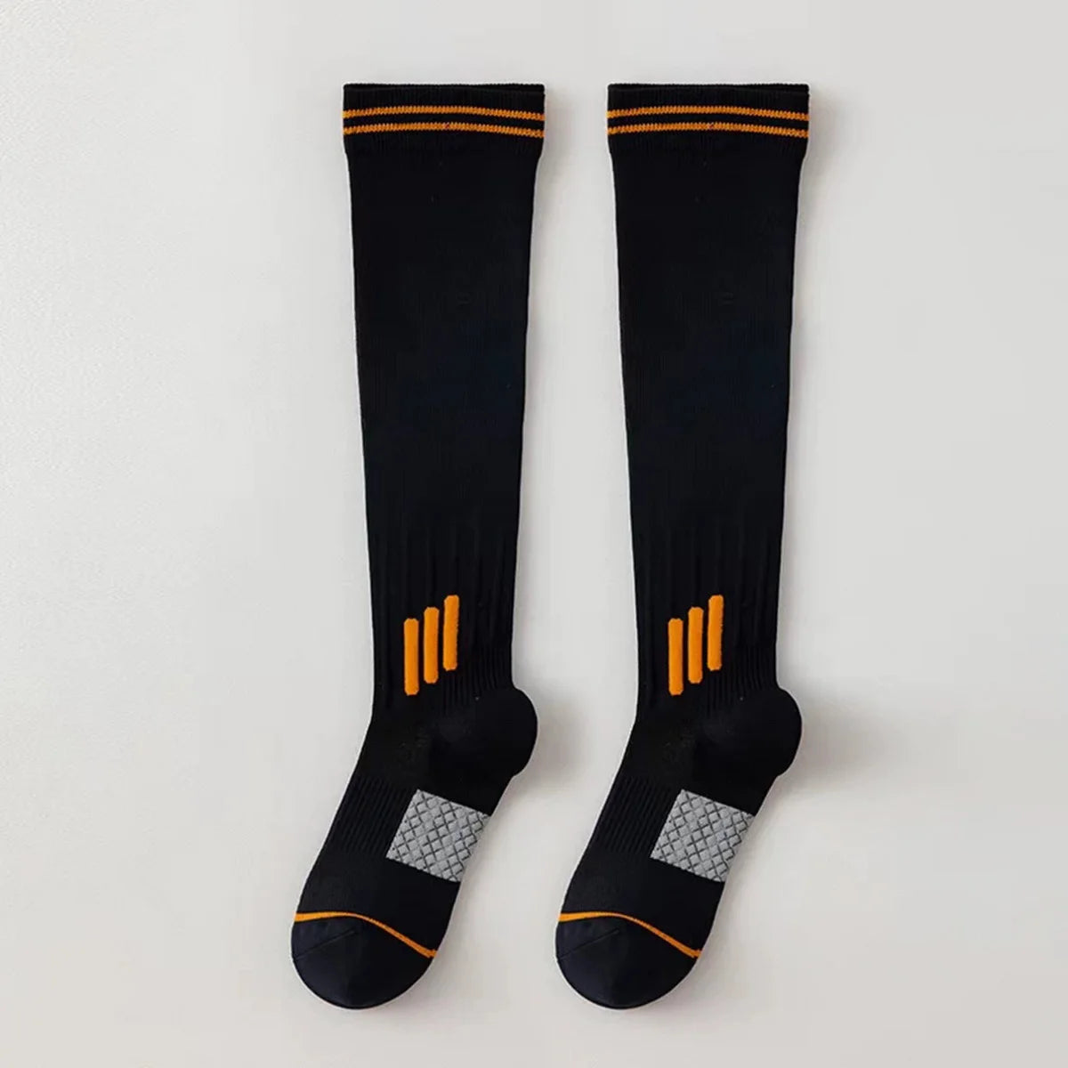 Pair of black knee high socks with orange stripes and silver accents for graduated compression.