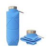 A light blue collapsible silicone travel water bottle with a silver cap, shown standing and folded.