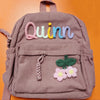 Mauve Corduroy Rucksack mit besticktem Namen Quinn, grünes Blatt und rosa Blumen