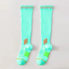 Pair of light aqua graduated compression knee high socks with orange trim and green accents