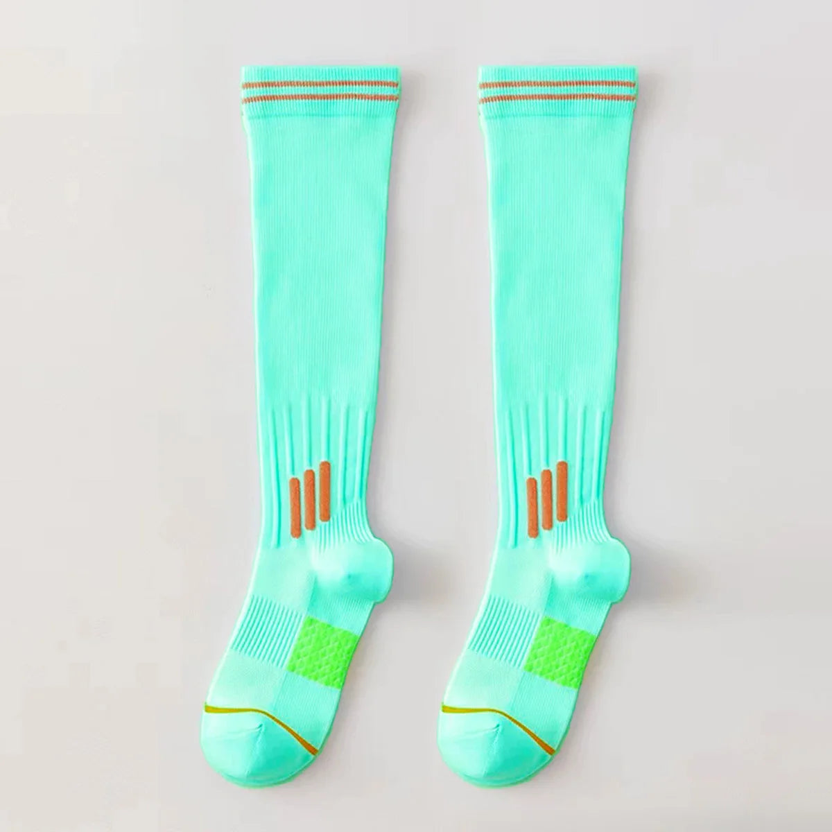 Pair of light aqua graduated compression knee high socks with orange trim and green accents