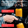 A hand opens a yellow double-wall insulated stainless steel thermos by pressing a lid and then lifting it to close.