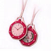 A pink octagonal pocket watch pendant with a rose gold chain and a detailed watch face.