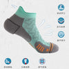 A pair of professional marathon running compression socks in gray and mint green, shown from the side.