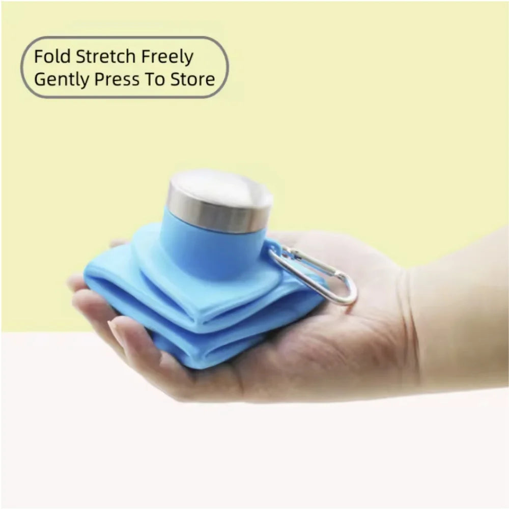 A hand holds a blue silicone collapsible water bottle with a silver cap, demonstrating its fold and stretch features.