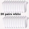 Twenty pairs of white comfort fit ankle socks arranged in a row.