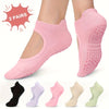 Two pairs of silicone yoga pilates socks in various shades of pink and green shown on a foot.