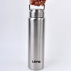 A silver stainless steel water bottle with a hinged lid is held by a hand.