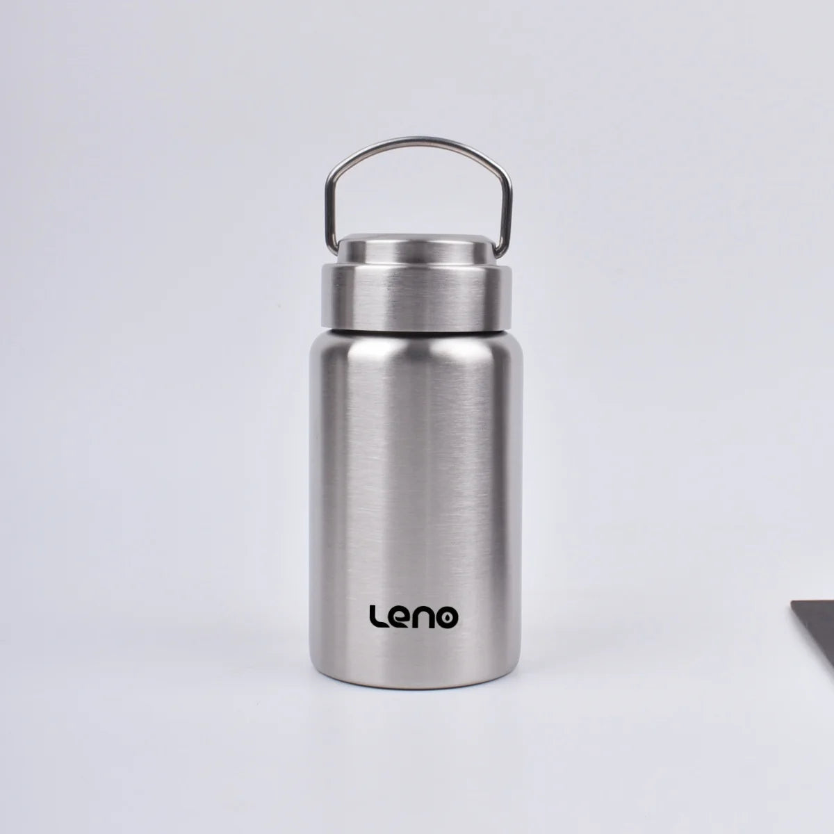 A silver stainless steel sport water bottle with a hinged cap is shown against a light gray background.