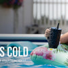 A woman relaxing in a pool with an insulated stainless steel water bottle.