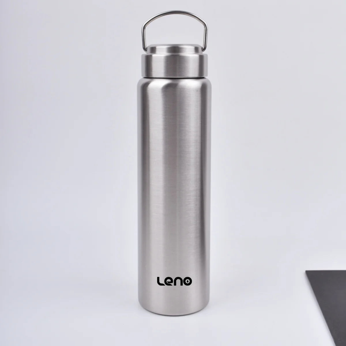 A silver stainless steel sport water bottle with a hinged cap standing upright on a white surface.