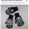 A pair of black skeleton hand gloves displayed against a white background.