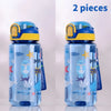 A clear silicone water bottle with a dinosaur design and blue lid, shown in two pieces.