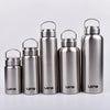 A row of four metallic silver sports water bottles with hinged lids standing side by side.