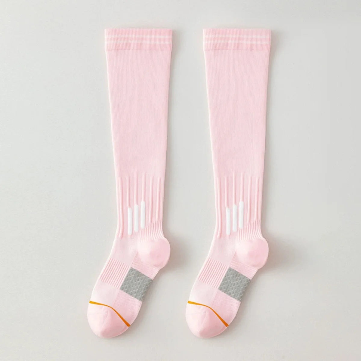Pair of light pink graduated compression knee high socks with white stripes and gray accents