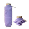 A purple collapsible silicone travel water bottle with a silver cap and clip.
