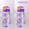 Two purple and pink unicorn silicone straw water bottles for kids