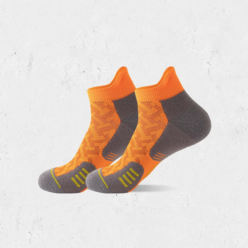 A pair of orange and gray compression socks for marathon running.