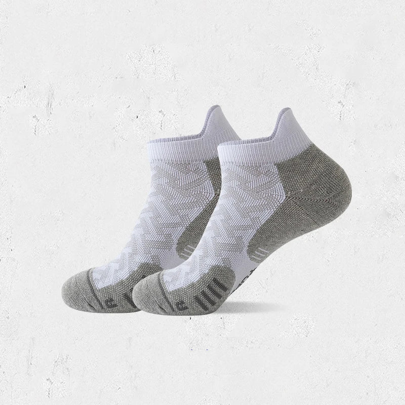 A pair of gray and white professional marathon running compression socks lying flat.