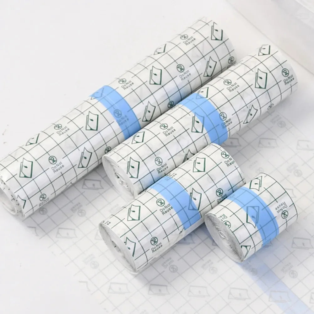 Rolls of waterproof film dressing for tattoo aftercare in white and light blue packaging
