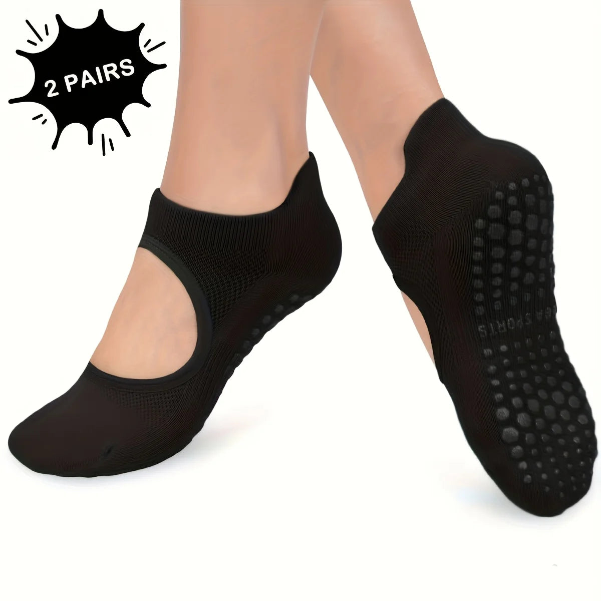 A pair of black silicone yoga pilates socks shown on a person's foot.