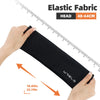 A hand is holding a black elastic fabric beanie hat, demonstrating its size against a ruler.