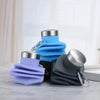 Three collapsible silicone travel water bottles in blue, purple, and gray with metal clasps.
