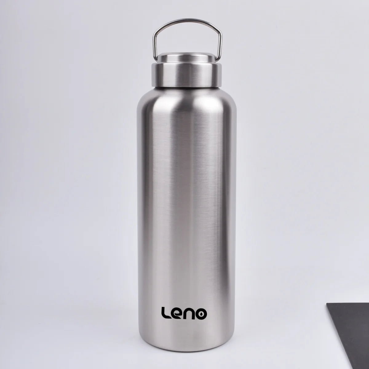A silver stainless steel sport water bottle with a hinged cap standing upright on a white surface.