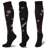 A set of multi-color compression socks featuring various heart and medical symbols on a black background.