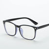 A pair of black full frame optical glasses with clear lenses and purple accents.