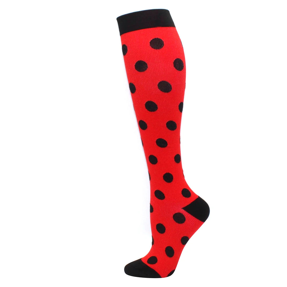 A pair of red compression socks with black polka dots.