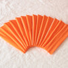 A fan of bright orange elastic headbands arranged in a semi-circle on a white surface.
