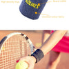 A close-up of a dark blue woven wristband with the AOLIKES logo being held by a hand near a tennis racket.