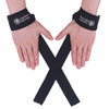 A pair of hands wearing black wrist straps with a white logo, crossed in an X shape.