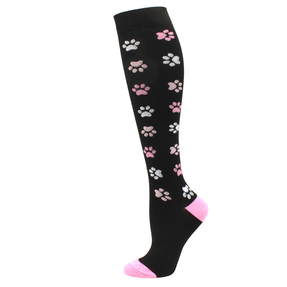 Black compression socks with pink paw prints and a pink toe section
