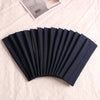 A fan of dark navy blue elastic headbands for sports and hair laid out on a light fabric.