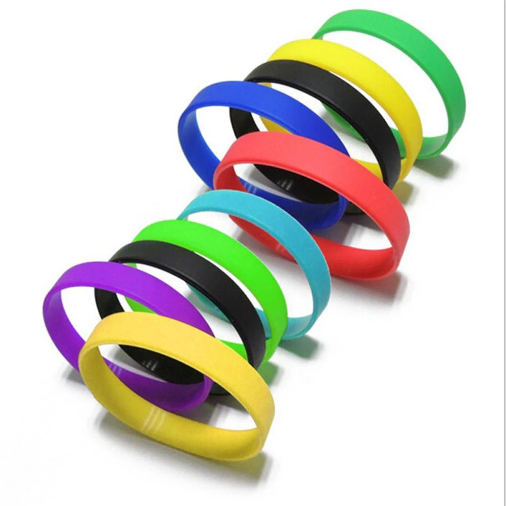 A collection of multi-colored silicone elastic wristbands in various bright colors like green, yellow, blue, and red.