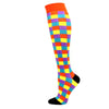 A pair of medical grade compression socks featuring a multicolored checkered pattern with orange accents.