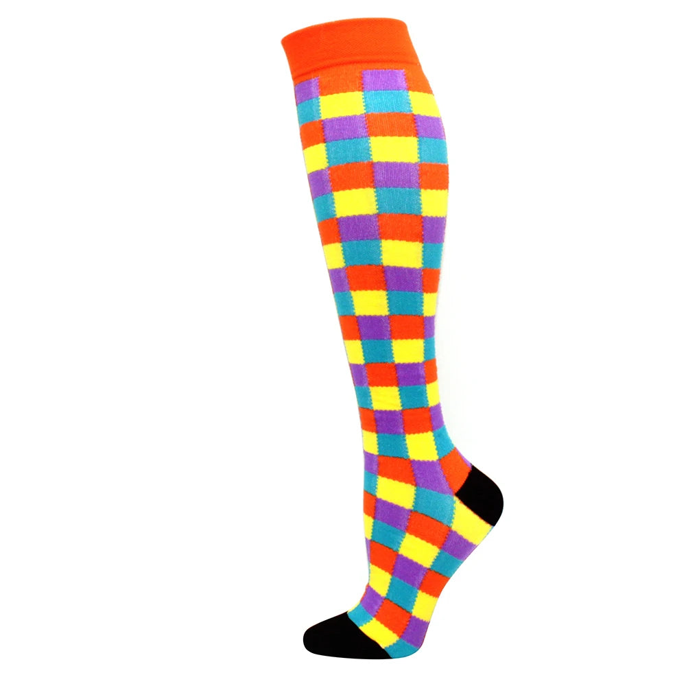 A pair of medical grade compression socks featuring a multicolored checkered pattern with orange accents.
