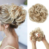 Close-up of blonde hair styled in a messy curly bun with extensions