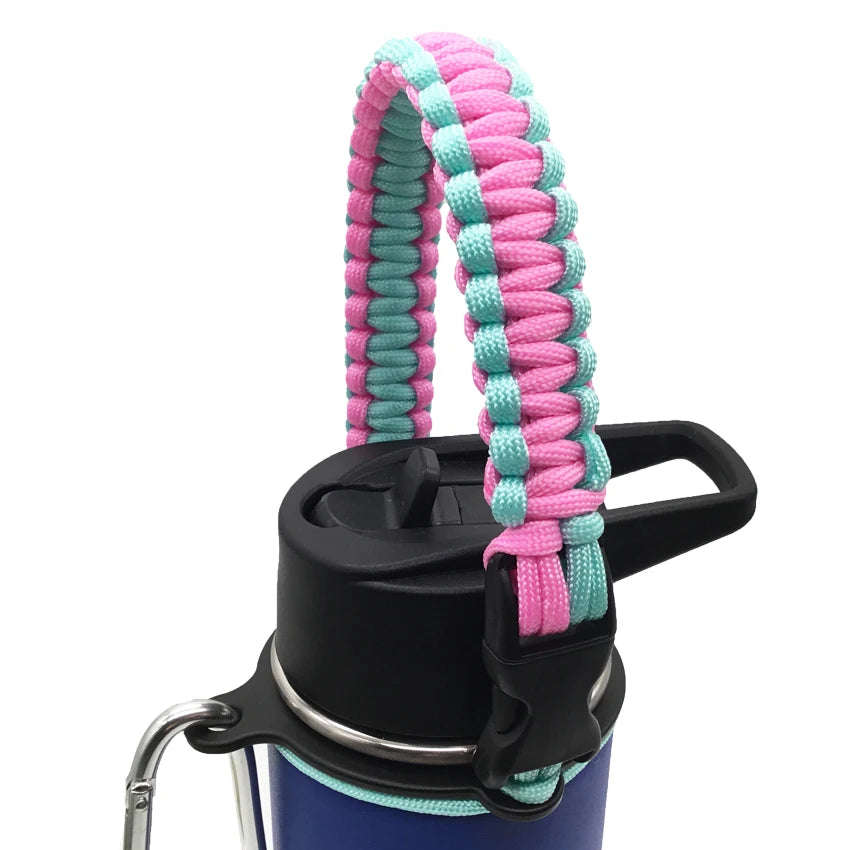 A paracord strap in pink and teal colors is attached to a black water bottle.