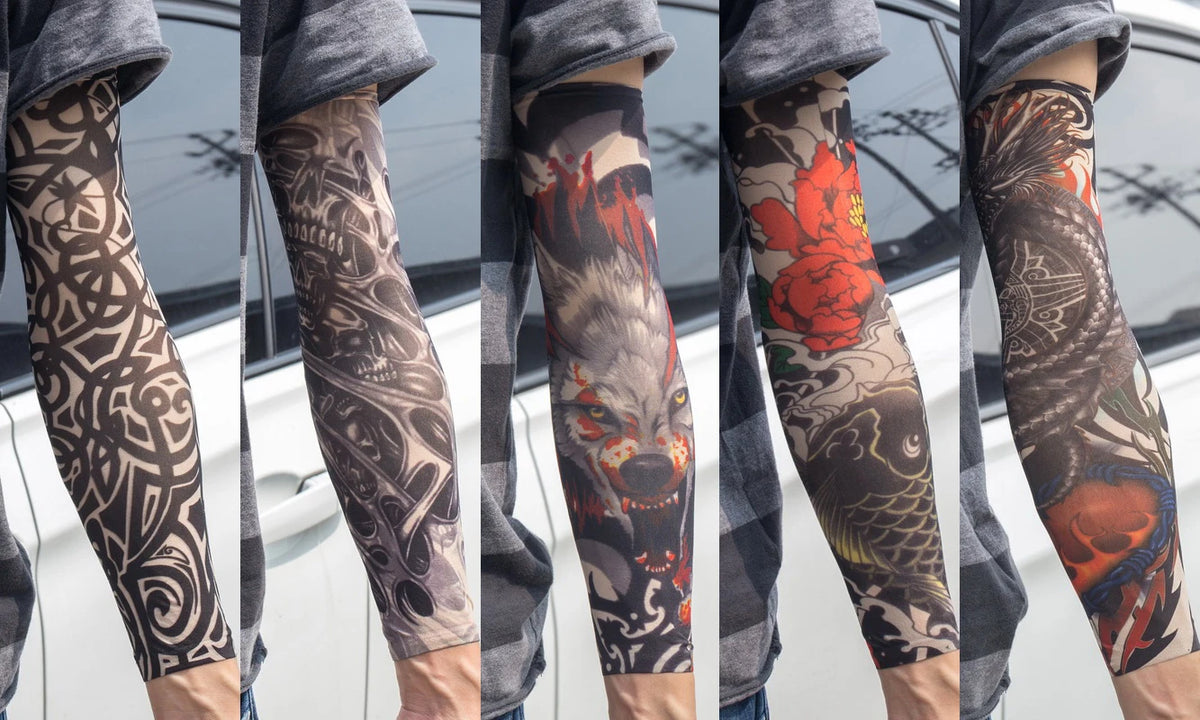 A person wearing dark patterned tattoo arm sleeves on their forearm, displayed against a light background.