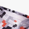 Close-up of a tactical arm sleeve fabric featuring a gray and black geometric pattern with orange accents.