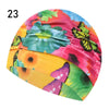 A vibrant pink and yellow floral print elastic nylon turban swimming cap shown from the side.