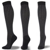 A set of black compression socks with white dotted lines shown vertically.